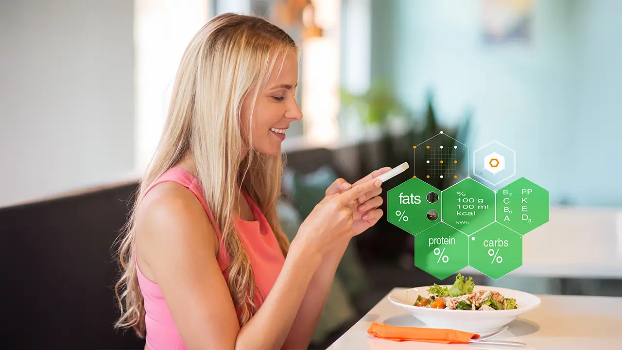 Woman tracking nutrition on her phone while eating a balanced meal, reflecting nutrition and food security in a changing climate.